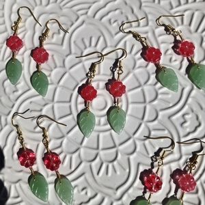 Flower drop earrings in pink and mint green one pair.